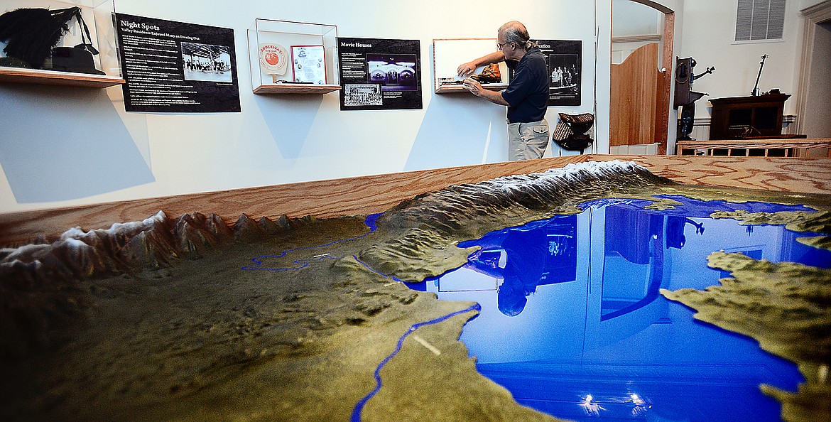 GIL JORDAN works on finishing touches to the &#147;History of the Flathead Valley&#148; exhibition in this file photo taken at the Museum at Central School in Kalispell. Jordan is retiring after 12 years as executive director in April.
(Brenda Ahearn/This Week in the Flathead)