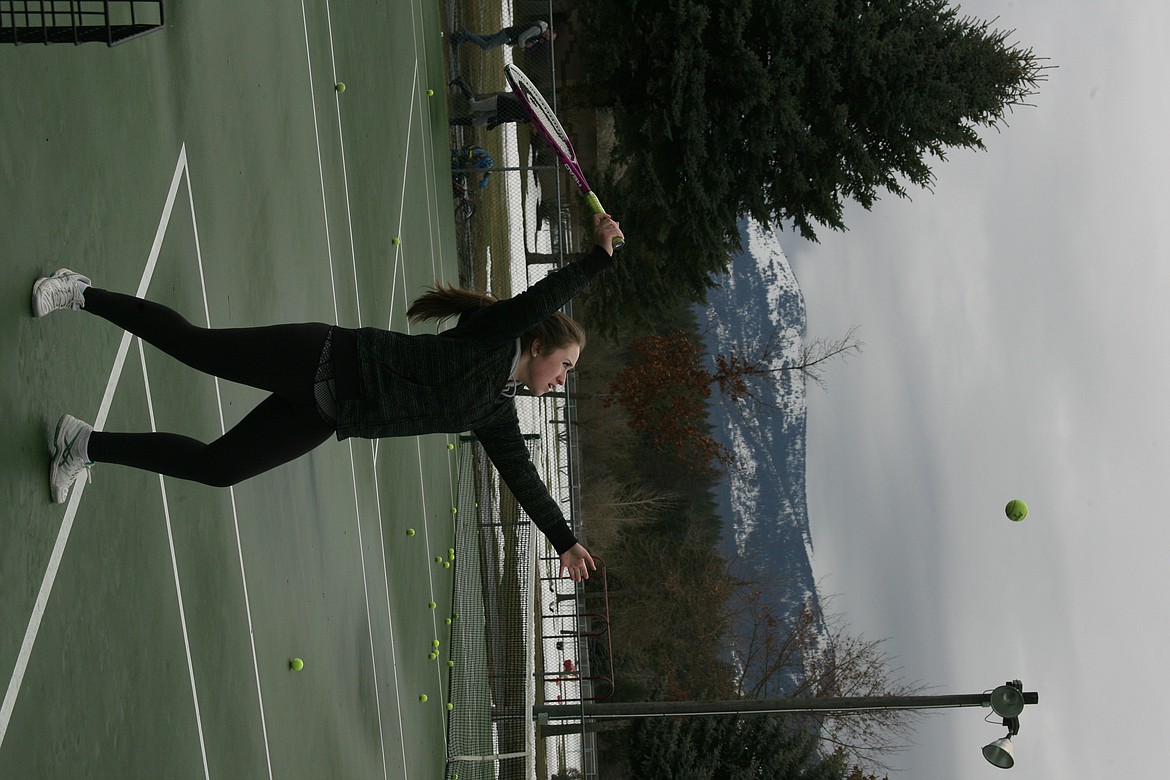 (Photo by ERIC PLUMMER)
Olivia Ramirez serves during an outdoor practice on Tuesday at Travers Park. The snow is finally gone, but the courts were still wet, but not enough to deter the Bulldogs.