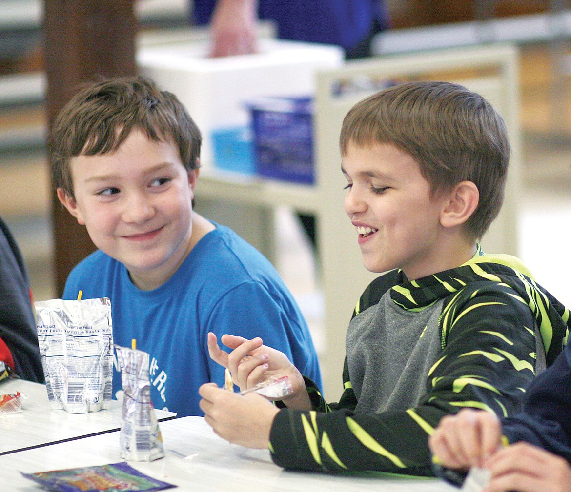Students in the Libby After School Program share a laugh during snack time. (Elka Wood/TWN)