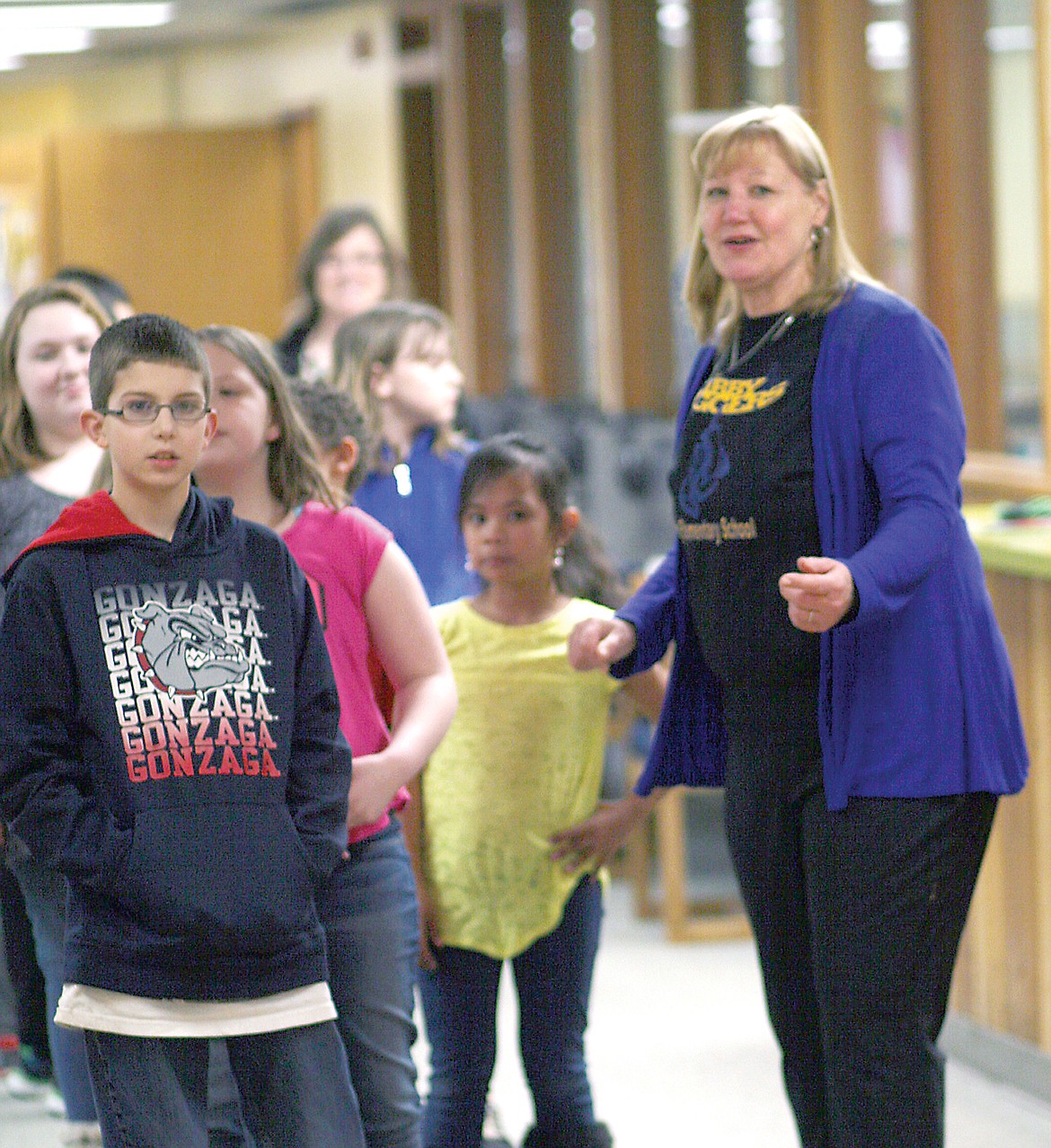 Libby After School Program director Mandy Bell leads students to their after school snack. (Elka Wood/TWN)