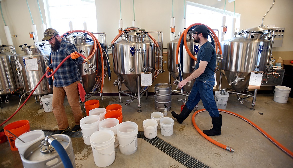 Rob Gambino, left, and Tom Hlavacek preparing their brewing projects on Monday, March 20, at the Flathead Valley Community College Brewing Science facility.(Brenda Ahearn/Daily Inter Lake)