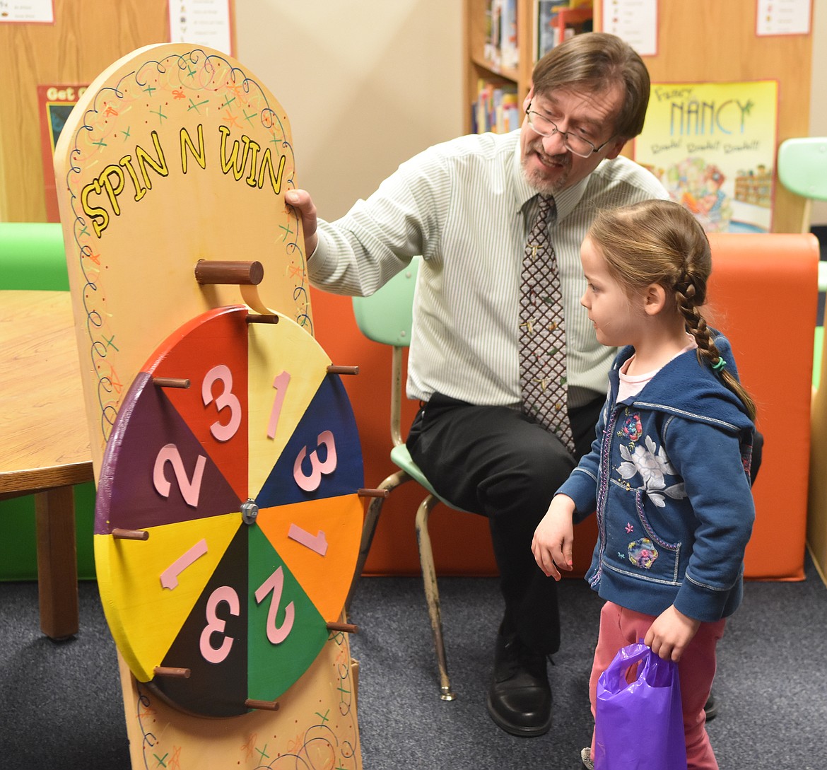 Lillian Perisho tries out the &quot;Spin n Win&quot; at Mully Night on Thursday.