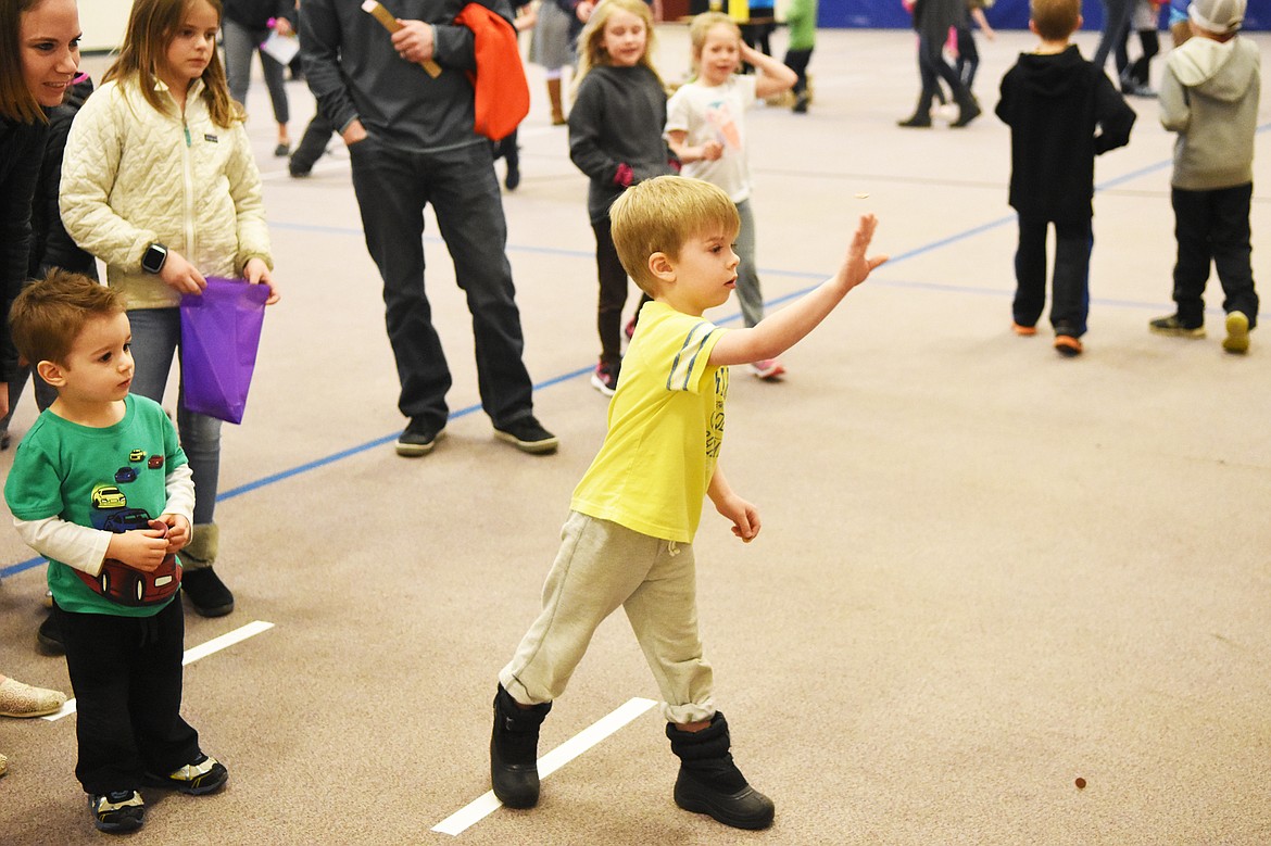 Kai Christ tries his hand at the penny toss at Mully Night on Thursday.