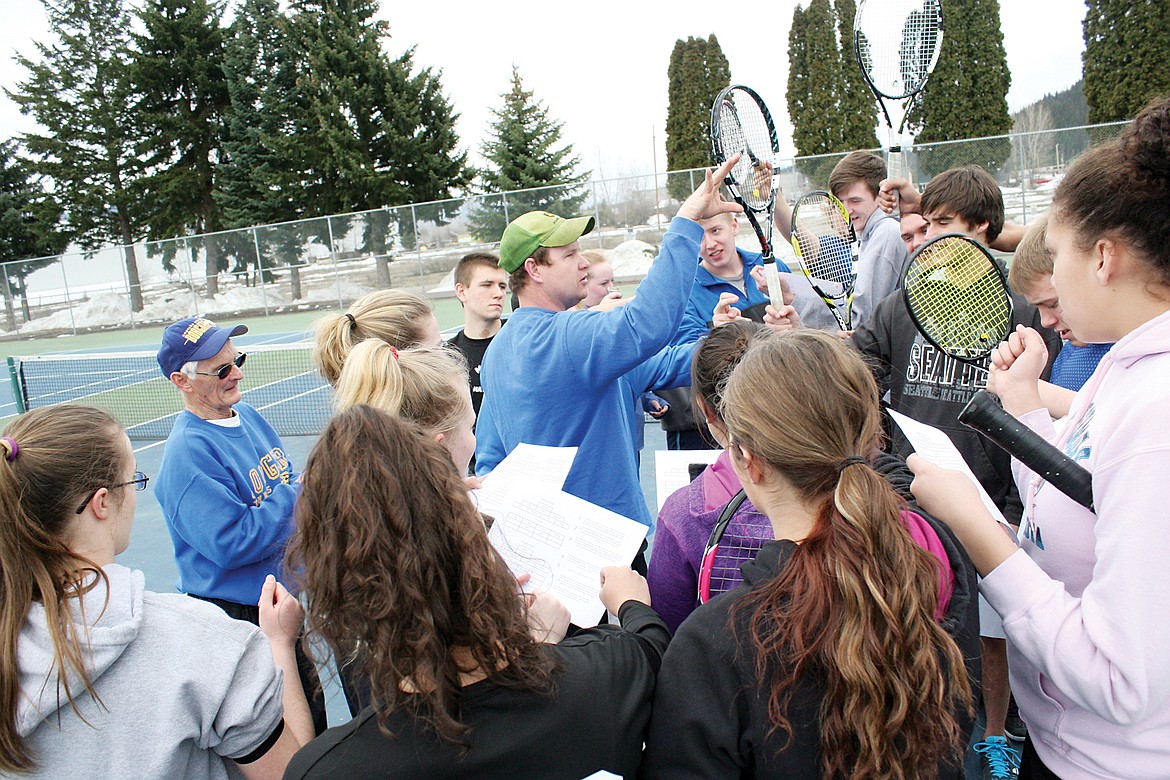 Tennis Coach Kyle Hannah greets and instructs his team before practice. &#147;Be better when you leave than when you got here.&quot; (Bethany Rolfson/TWN)