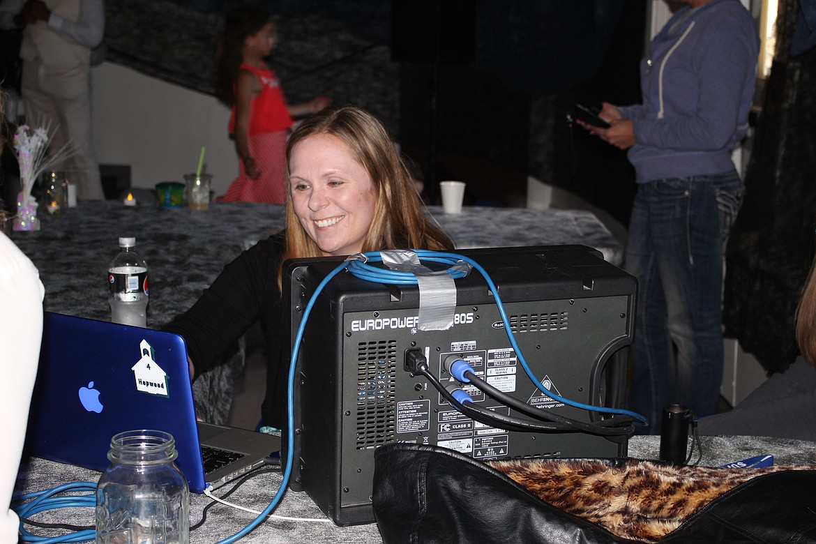 Superior teacher Angie Hopwood mixed the music during the Superior Girl Scout Troop Father-Daughter Dance on March 19. (Kathleen Woodford/Mineral Independent).