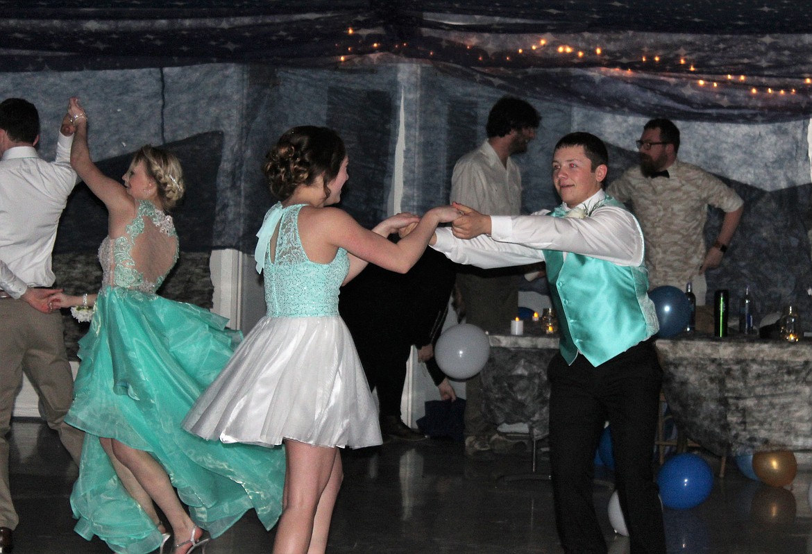 Wyatt O&#146;Day, far left, and Kaylee Ray, Sophia Krutilla and Tucker McLees twirl their way through a dance at prom. (Photo by Frankie Kelly)