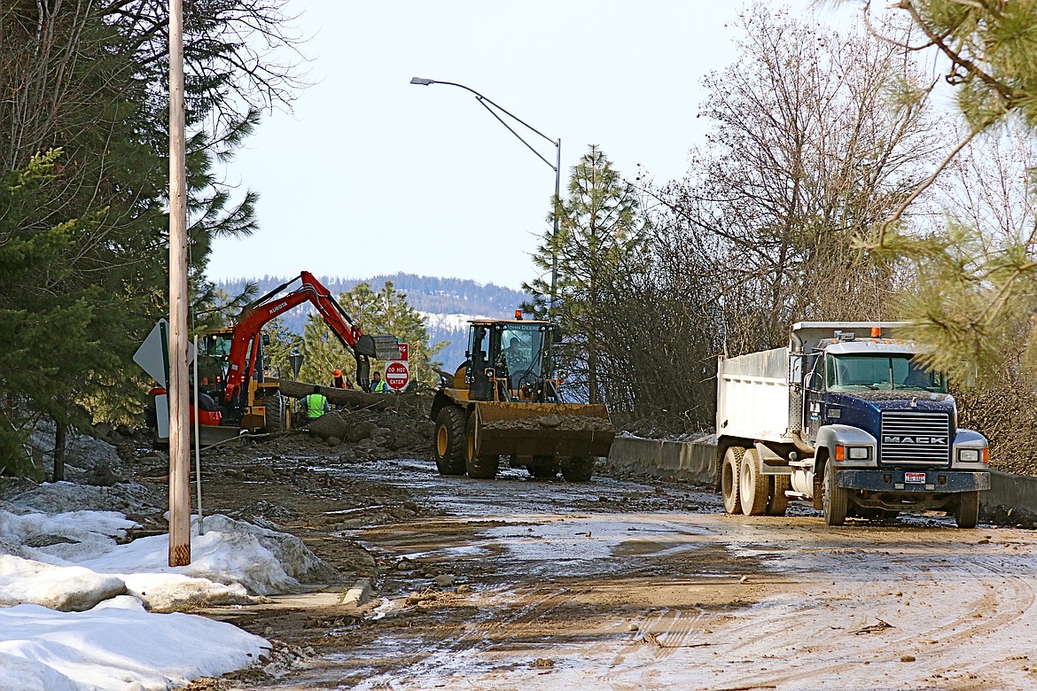 (Photo by STAR SILVA)
City, County, and ITD crews clean up downed trees and debris on Monday in the wake of Saturday&#146;s mudslide on U.S. Highway 95 and Ash St. in Bonners Ferry.