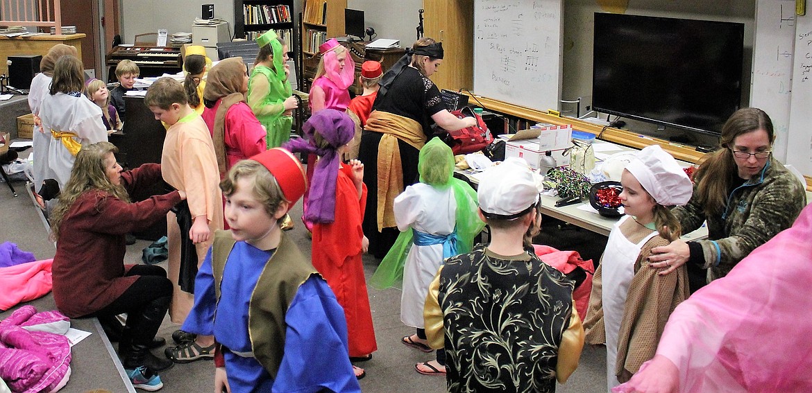 Backstage, Amy Farris, Michelle Simpkins and Shelly Larson get costumes and makeup on students for the play &#147;Aladdin Jr.&#148; in St. Regis.