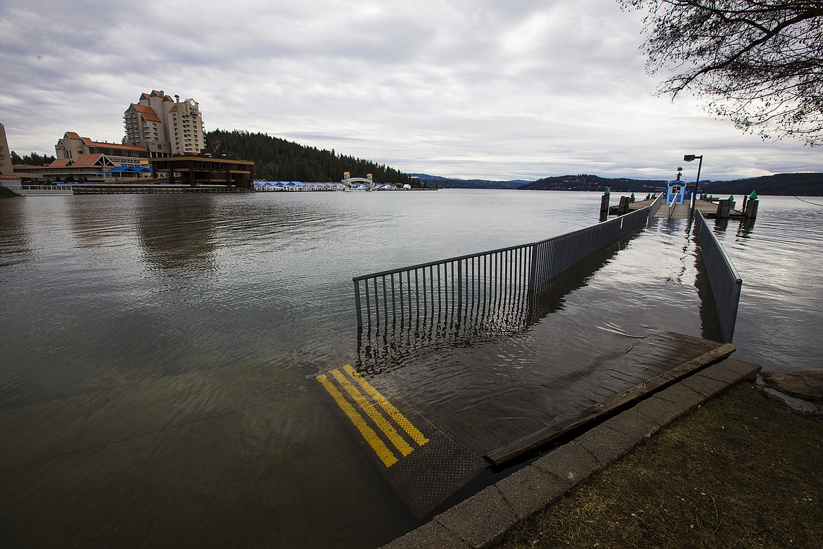 LOREN BENOIT/PressWater from Lake Coeur d'Alene floods over the bridge to Coeur d'Alene Parasail Monday afternoon.