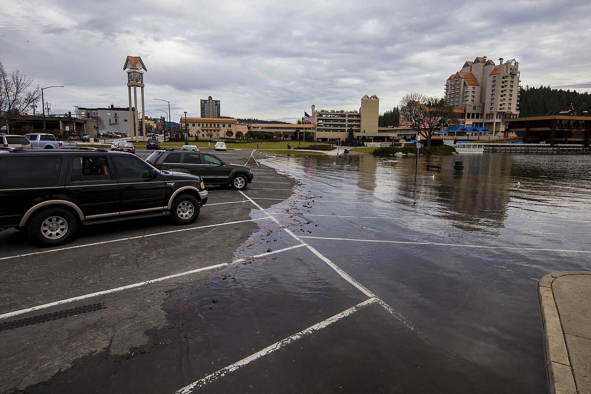 LOREN BENOIT/PressWater from Lake Coeur d'Alene floods into the Independence Point parking lot Monday afternoon.