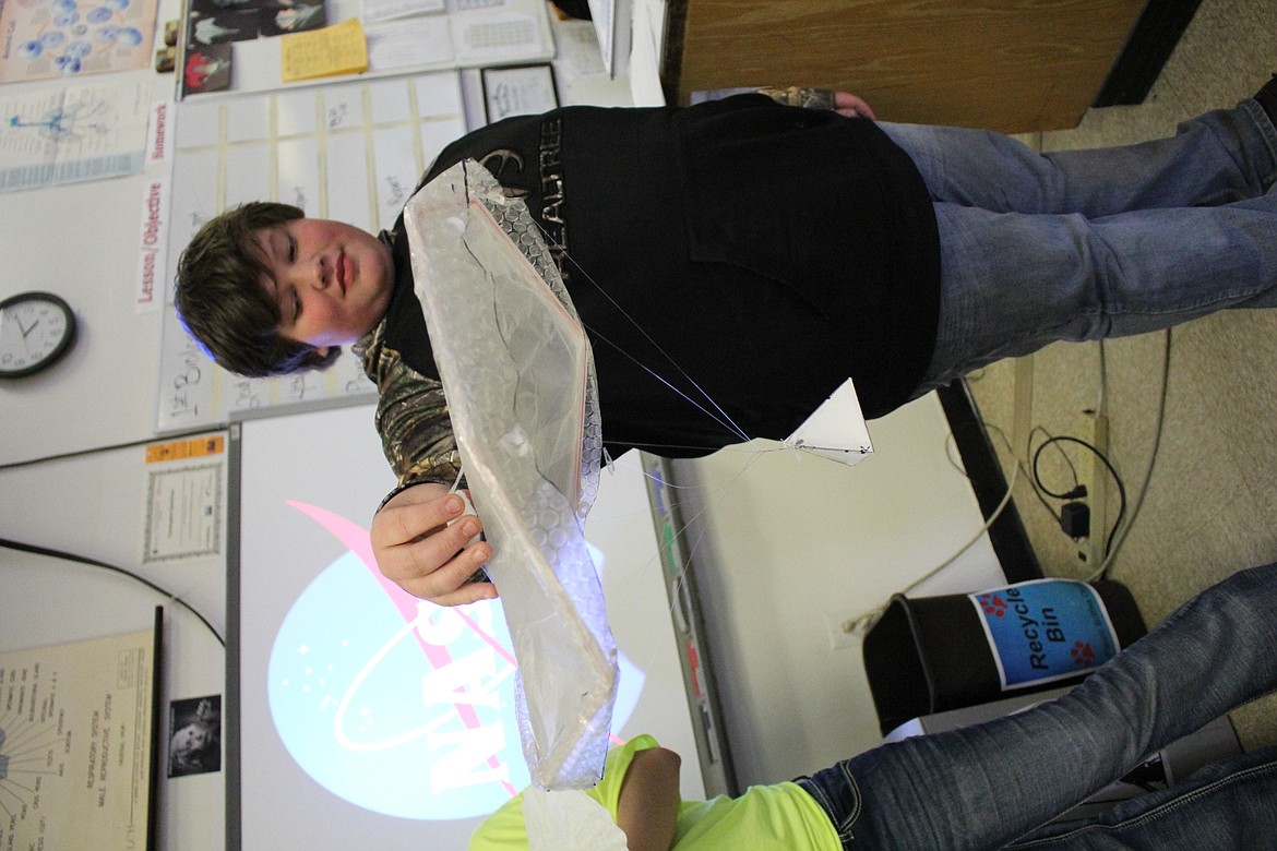 Superior eighth-grader Eric Vantassel holds his teams parachute made from bubble wrap, fish line and five pennies. They had to follow specific requirements in order to compete in a recent NASA project. (Kathleen Woodford/Mineral Independent).