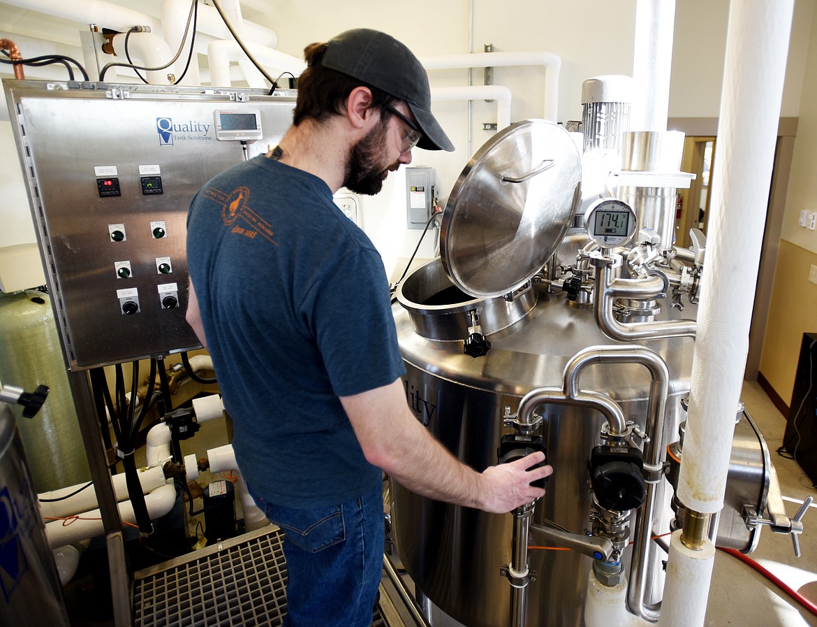 Tom Hlavacek begins a beer brewing project on Monday, March 20, at the Flathead Valley Community College Brewing Science facility.(Brenda Ahearn/Daily Inter Lake)