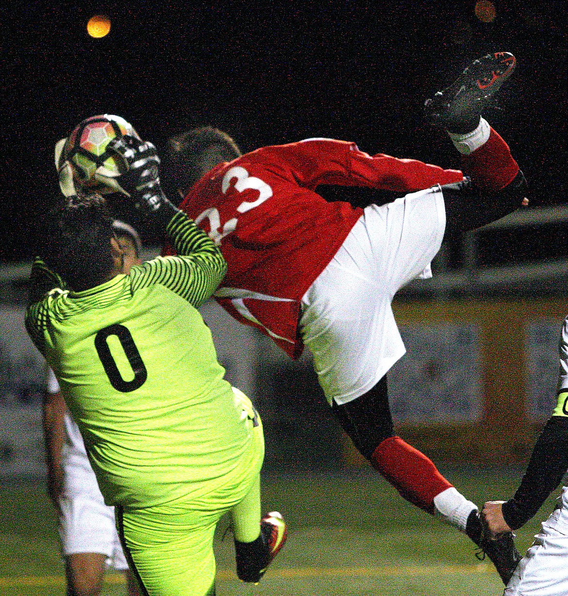 Rodney Harwood/Columbia Basin HeraldMoses Lake goaltender Eddie Reyes snatches the ball away from a high-flying Jose Guerrero of Eisenhower on a corner kick in the second half of Friday's match at Lions Field.