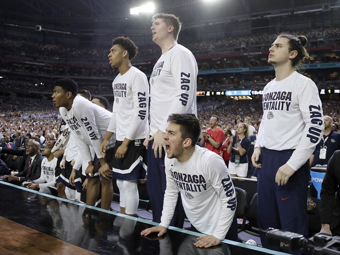 Gonzaga players react on the bench during the first half against North Carolina in the finals of the NCAA basketball tournament, Monday in Glendale, Ariz. Glacier High graduate Ryan Edwards (third from right) was the second player from Kalispell to make the championship game. (AP Photo/Mark Humphrey)