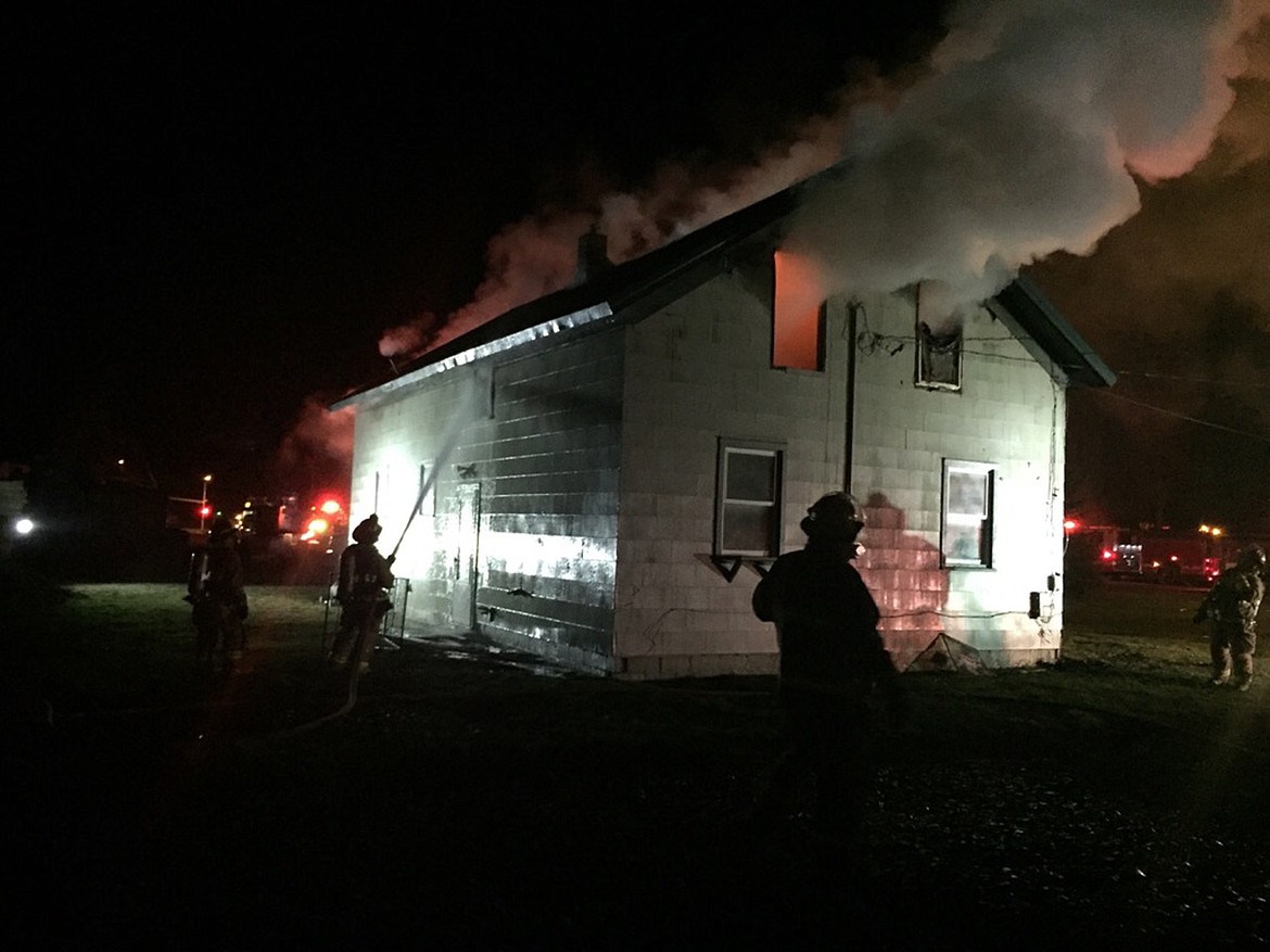 Firefighters battle a fire in a two-story rental property on Sunset Drive in Evergreen early Wednesday morning. (Stephanie Daugherty/Daily Inter Lake)