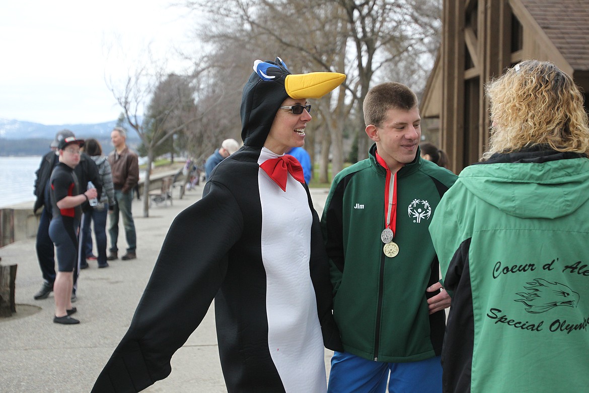 DEVIN HEILMAN/Press
Penguin Plunge cheerleader Jann Kinnard and her son, Special Olympics athlete Jim, visit with friends Saturday during the 12th annual Penguin Plunge. The fundraiser helps support the nonprofit so its athletes can participate in events throughout the year.