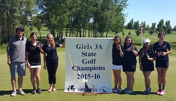 Courtesy photo
Kat Rauenhorst and her teammates stand with their former coach Carter Wardwell after receiving their championship banner.