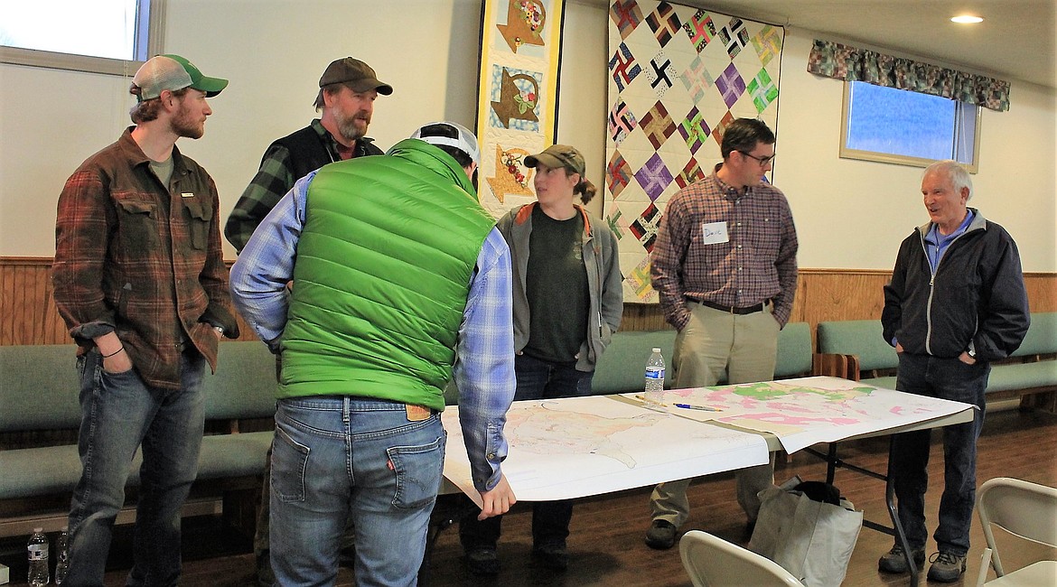 After Forest Service representatives gave brief presentations about their areas of expertise, the public was able to visit with them and look at maps of the Redd Bull project area located near St. Regis. (Kathleen Woodford/Mineral Independent).