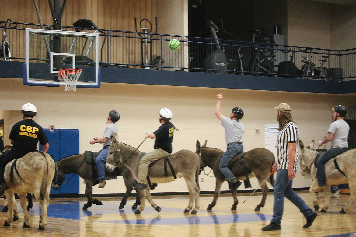 &#151;Photo by MANDI BATEMAN
National Guard aiming for the basket during the Donkey Basketball game.