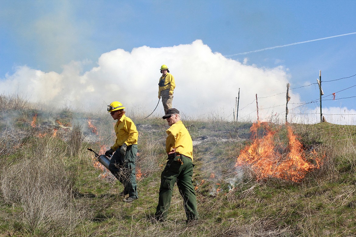 from left: Ian Smith, Brian Reed (with fire hose), and Marlin Cooper on the controlled burn training near Plains.