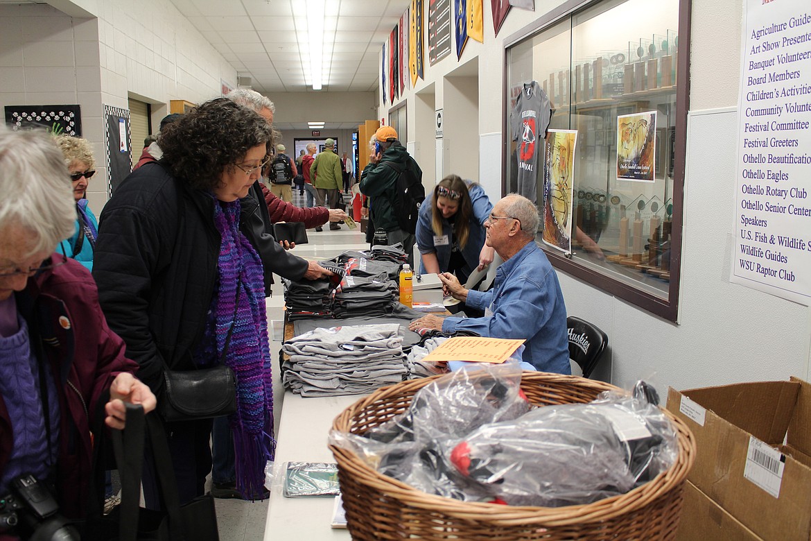 Chanet Stevenson/The Sun Tribune - Laura Cooke and Don Larson showcase the many different souvenirs offered during the 20th Annual Othello Sandhill Crane Festival Saturday.