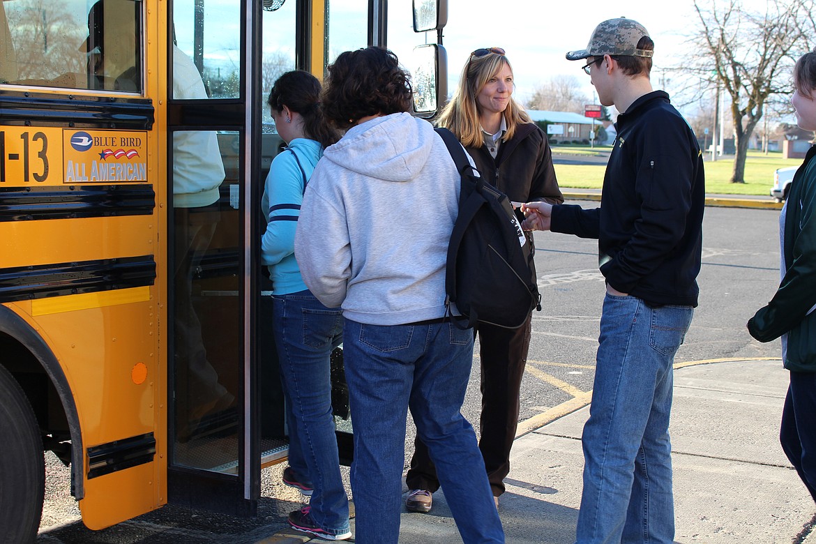 Chanet Stevenson/The Sun Tribune - Denise McInturff greets visitors as they board the tour bus Saturday. The bus tours shuttled visitors to various viewing areas, giving them an opportunity to see the Sandhill Cranes first hand.