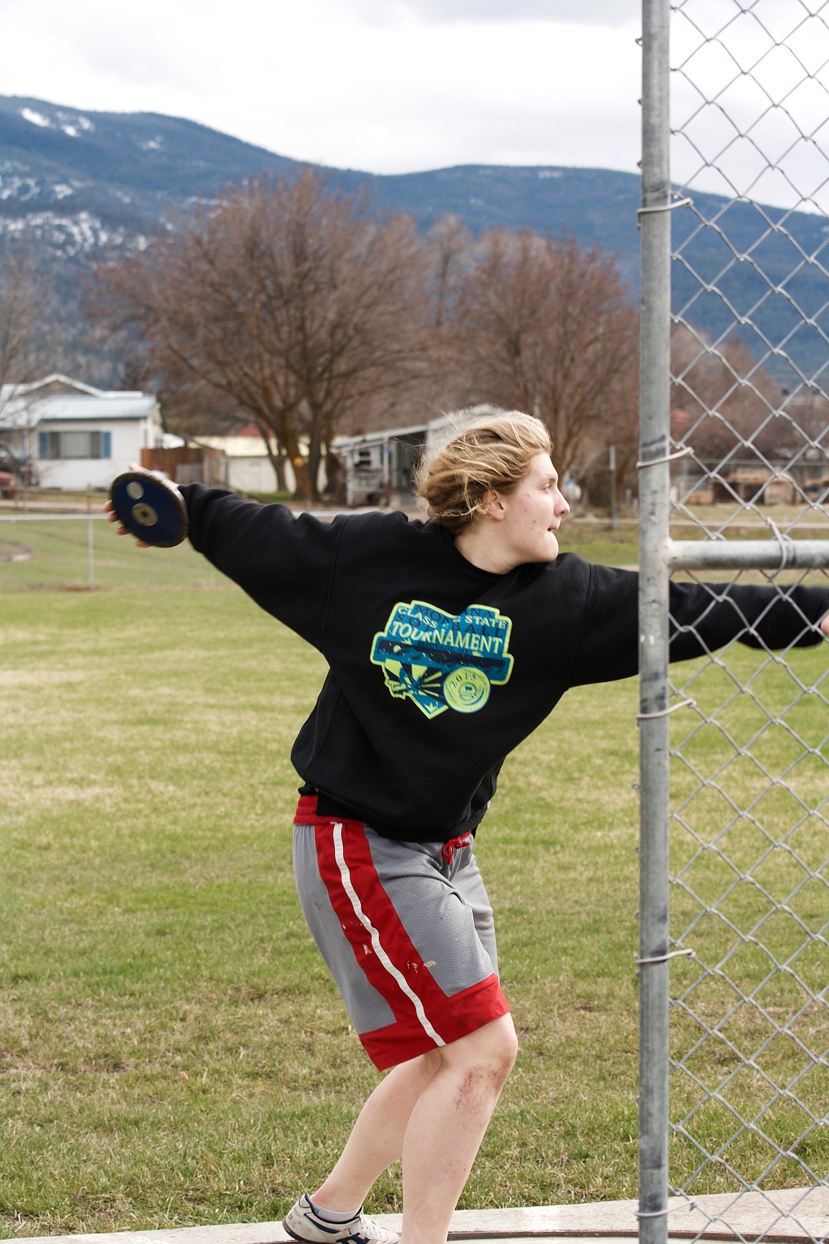 JESSICA THOMPSON of the Plains team begins her slide and throw of the discus during a recent practice. (Douglas Wilks photos/Clark Fork Valley Press)