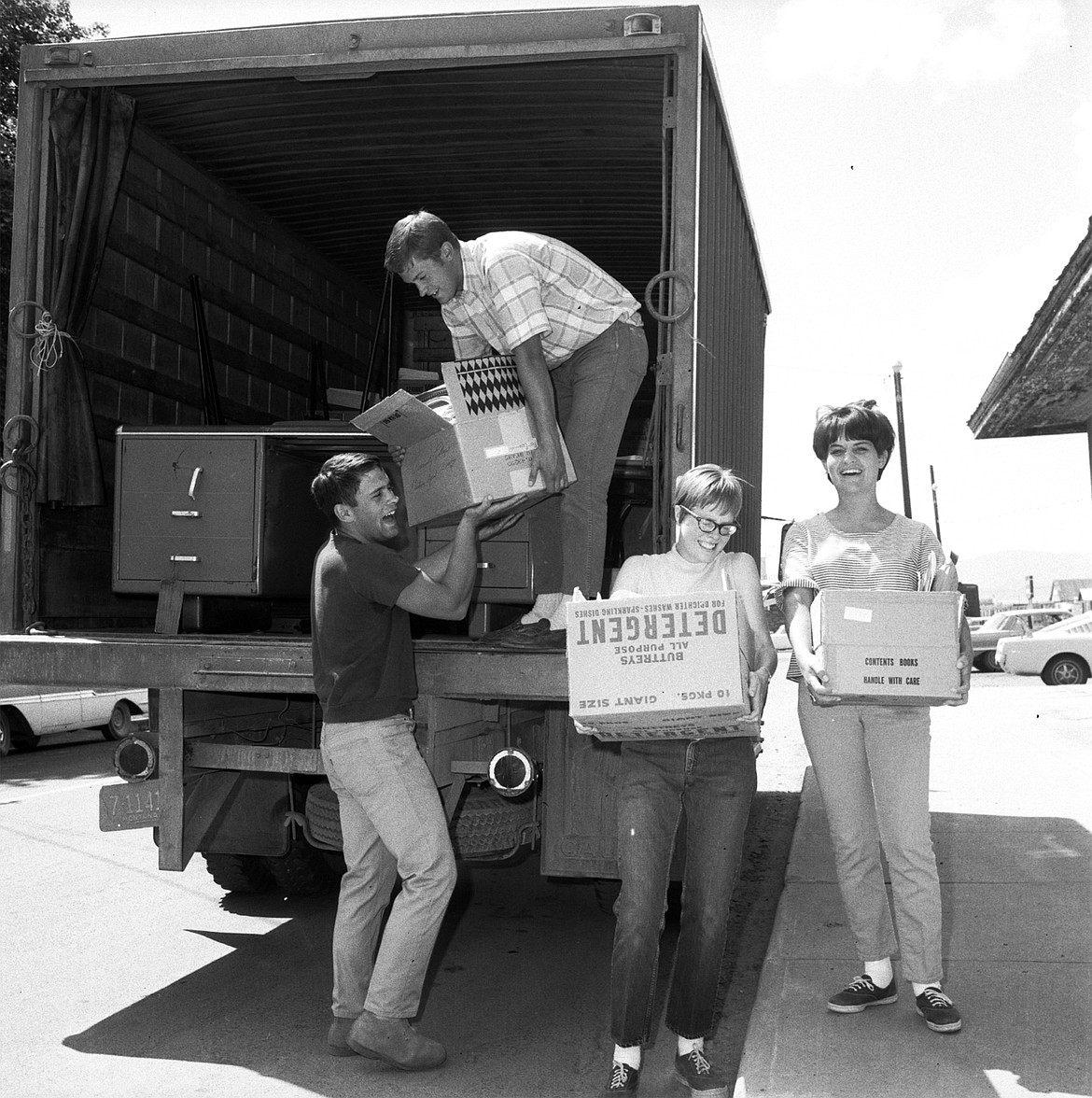 It was moving day Monday for the FlatheadValley Community College. Boxes of supplies,office furniture, typewriters, everything wasmoved out of the old Post Office Building tothe Depot Building. Here Bruce Quande, summerwork-study student from the University of Montana, hands boxes down out of the moving truck.  Receiving the box from Quandeis Ron Phelps, another work-study student.Pat Elliott, wearing glasses, strains with abig box. She is a university work-study student.At right is Darlene Wirtz, CommunityCollege secretary. (Inter Lake staff photo)