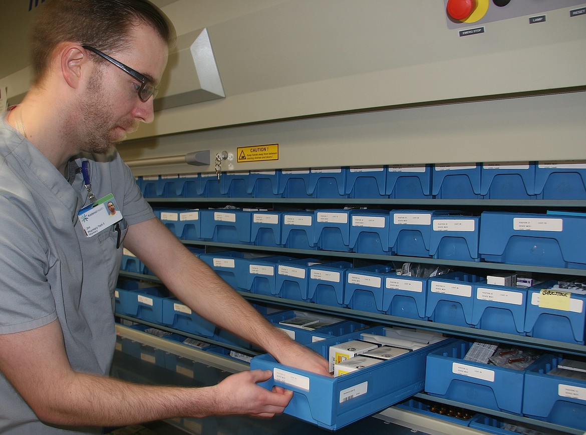 BRIAN WALKER/Press
Joe Rigoli, a Kootenai Health pharmacy technician, tends to the &quot;Med Carousel&quot; where medications are stored and organized.