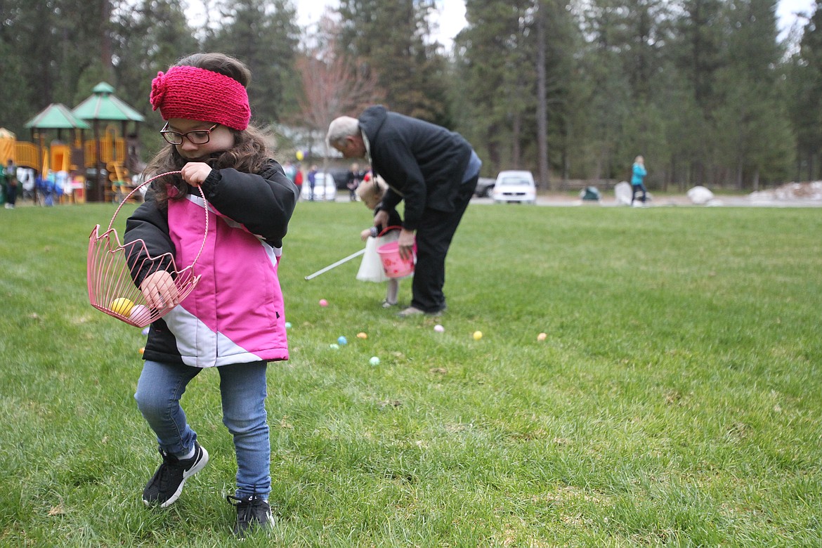 DEVIN HEILMAN/Press
Sophia Pullen, 3, of Coeur d&#146;Alene, inspects her findings Saturday at the start of the beeping Easter egg hunt in Kiwanis Park in Post Falls. The beeping helped the blind and visually challenged kiddos know where to search for eggs.