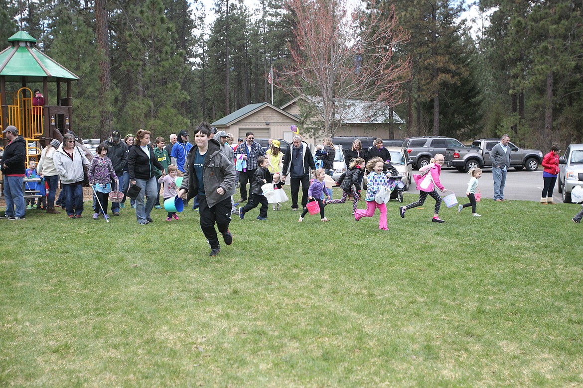 DEVIN HEILMAN/Press
Squealing children, with and without vision challenges, spread out across Kiwanis Park in Post Falls to gather eggs during the beeping Easter egg hunt Saturday.