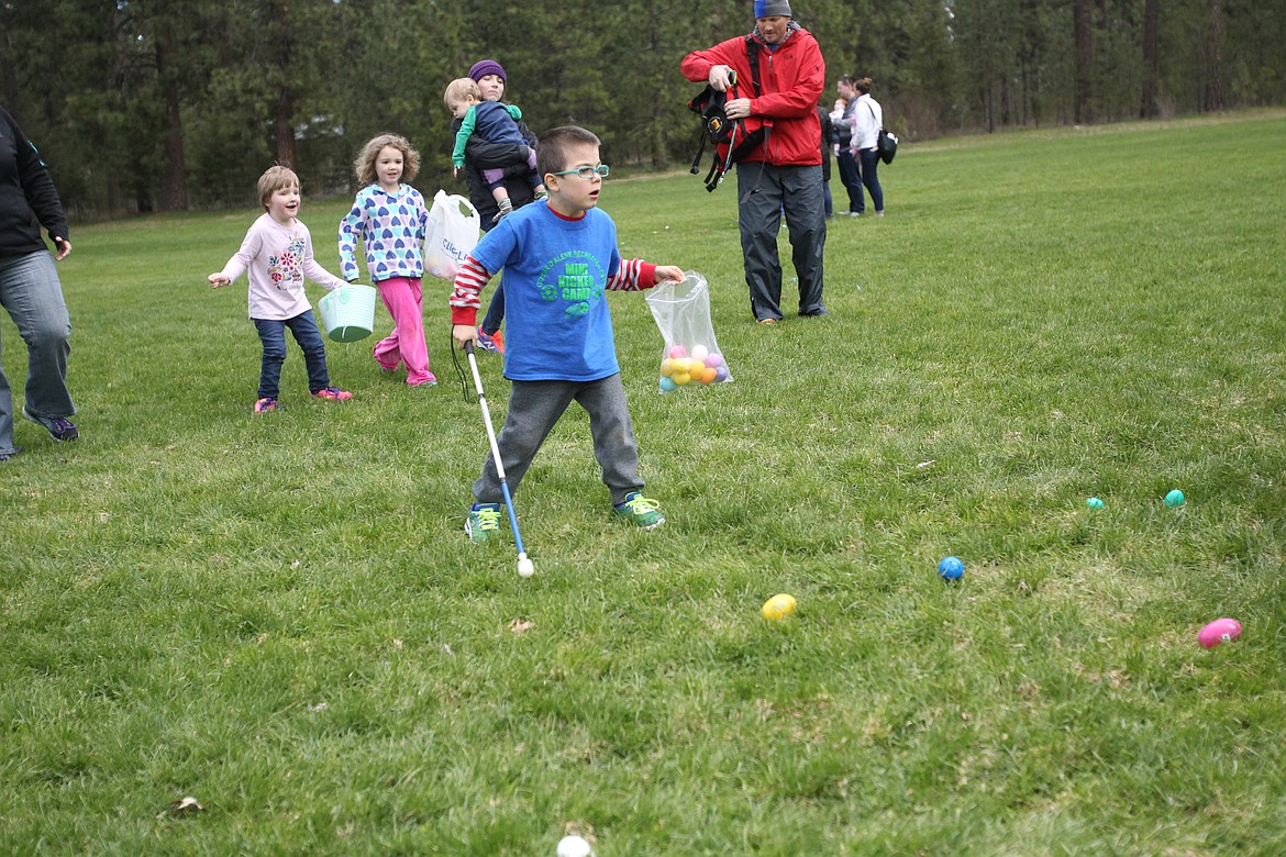 DEVIN HEILMAN/Press
Mac Rigg, 6, of Post Falls surveys his surroundings Saturday as he collects Easter eggs in Kiwanis Park.