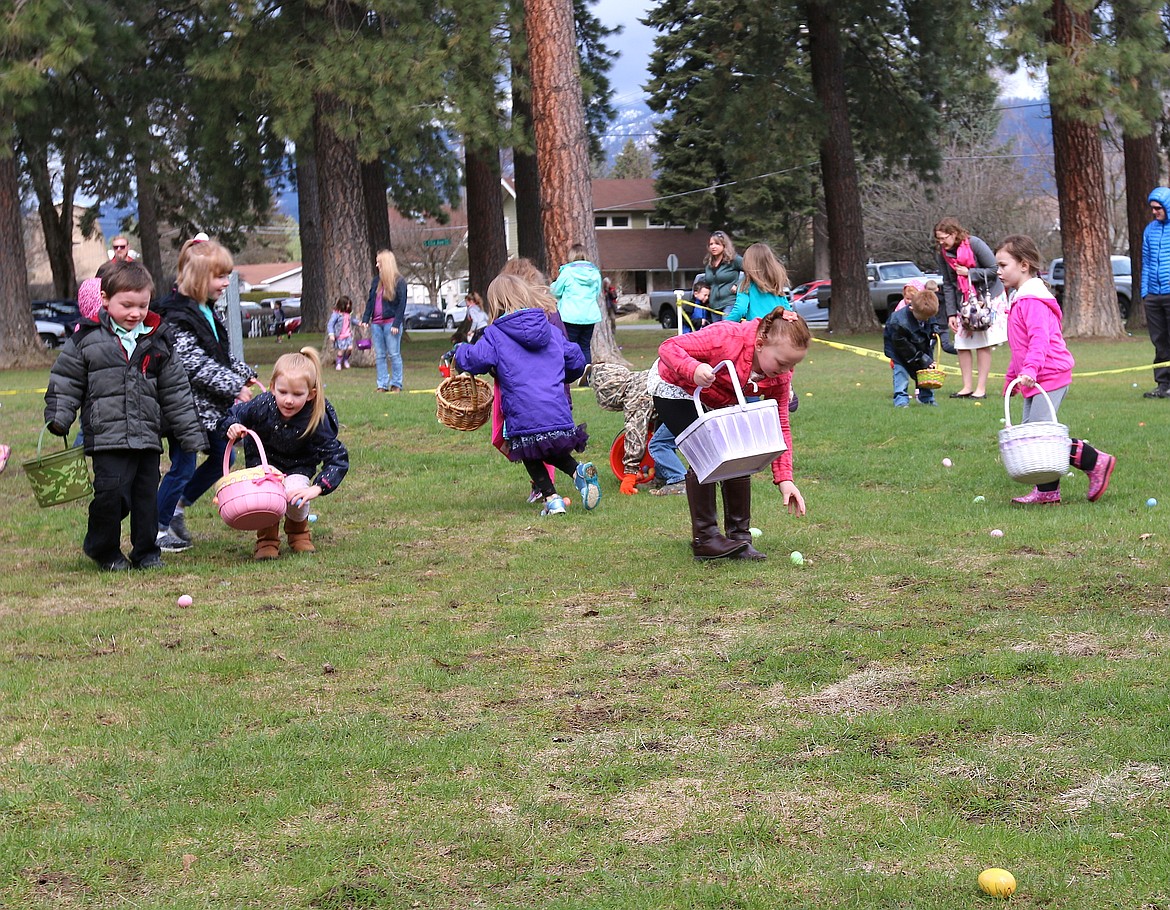 (Photo by CAROLINE LOBSINGER)
Local youngsters race around Lakeview Park as they hunt Easter eggs at the Sandpoint Lions' annual event. Hundreds of local youngsters packed the park to hunt for the holiday treats despite a cooler-than-average day.