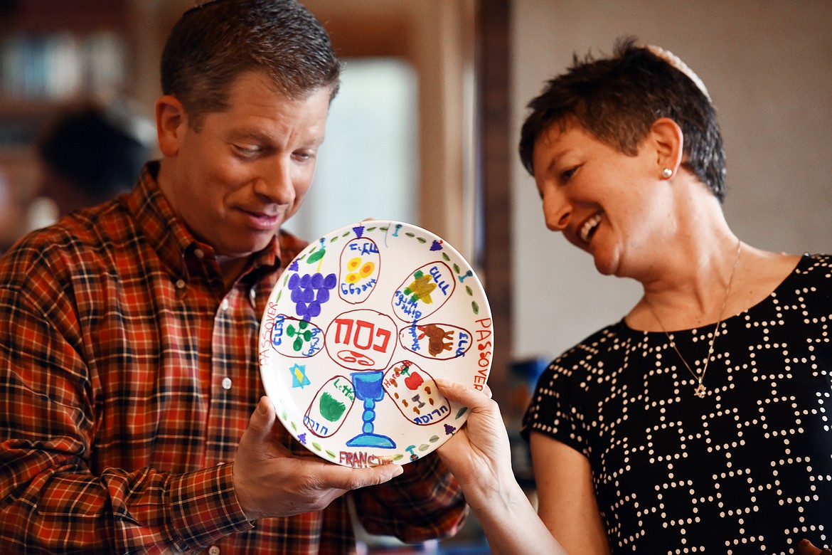 Marc Roston brings out a Seder plate his wife, Francine, made when she was in second grade to show to their guests.