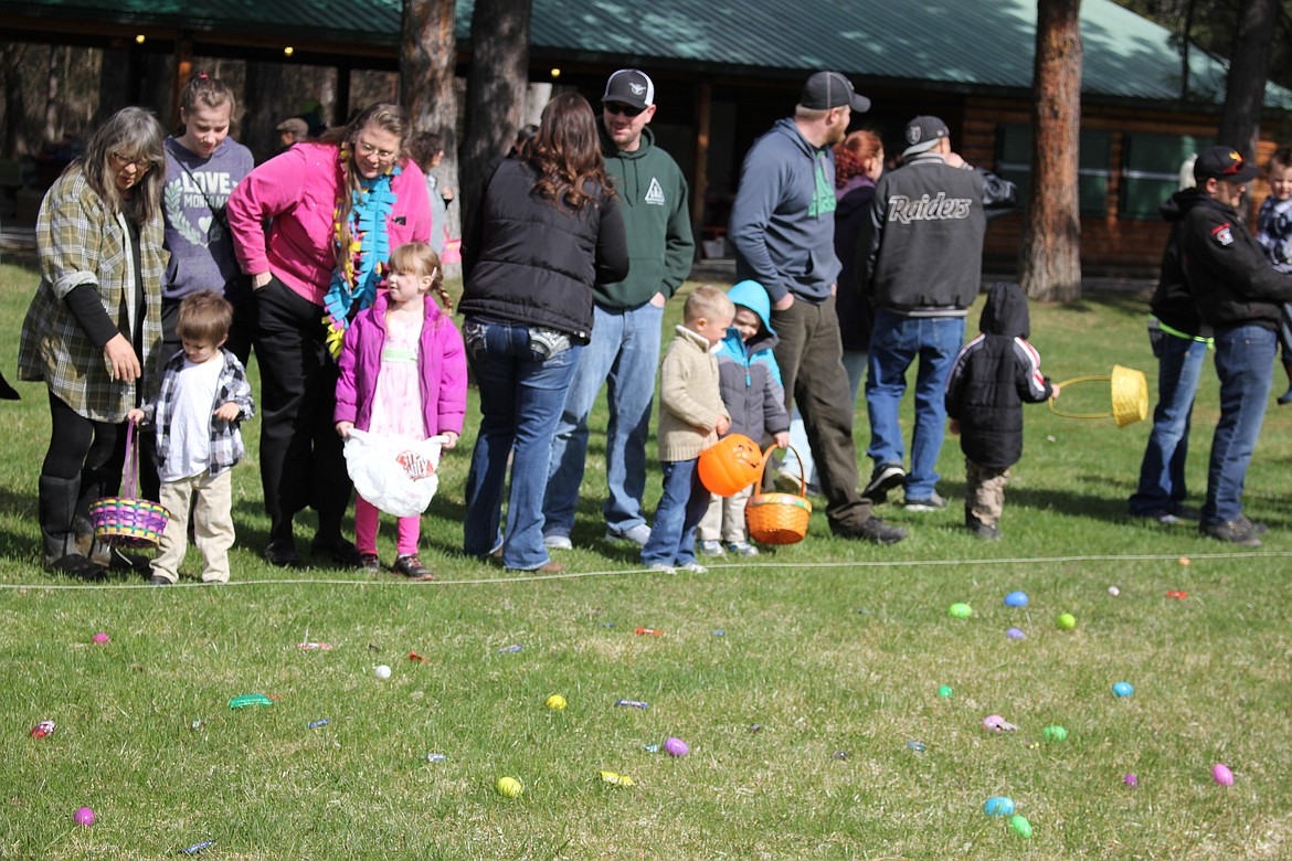 Preschoolers lined up with their plastic bags, baskets, and even a Halloween container to gather up candy and eggs. (Kathleen Woodford/Mineral Independent).