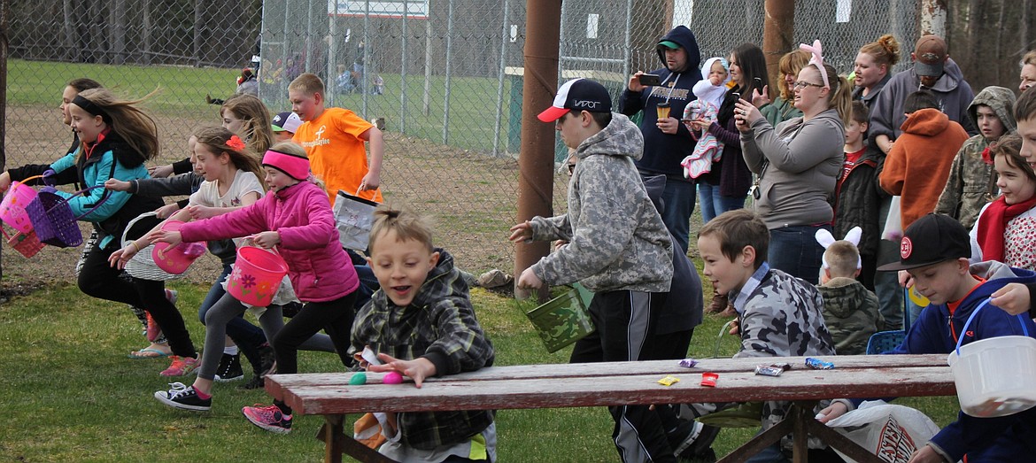 The 9 and 10-year-olds raced around the baseball field and flag pole in the St. Regis Park on Saturday to hunt for eggs and prizes. (Kathleen Woodford/Mineral Independent).