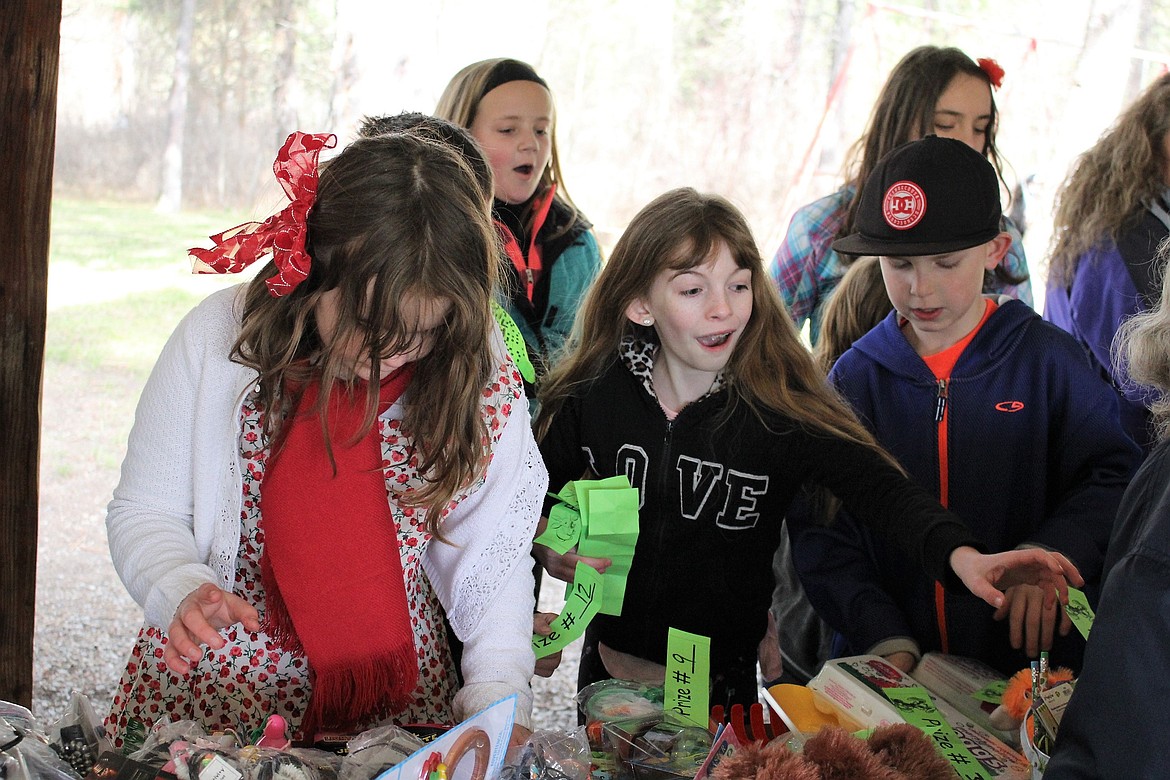 Kids pick out the toys they want, which were donated by local businesses and the St. Regis Community Council. (Kathleen Woodford/Mineral Independent).