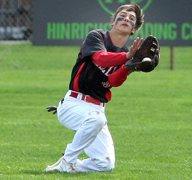 Rodney Harwood/Columbia Basin Herald - Othello center fielder Jaxon Rocha makes a sliding catch during the first game of Saturday's CWAC doubleheader with Ellensburg.