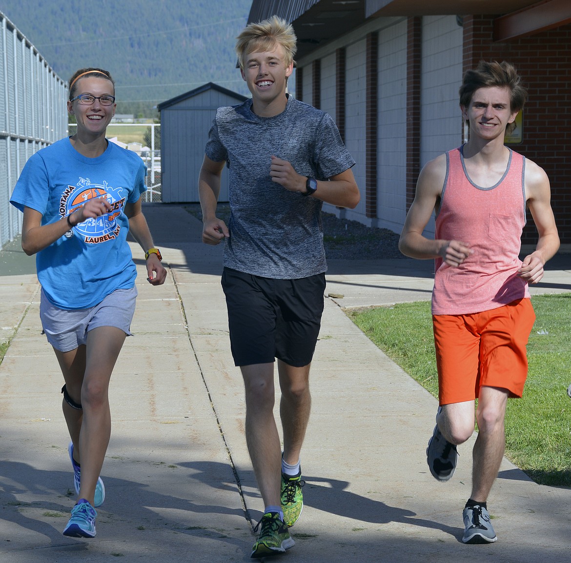 RONAN CROSS country runner Ashley McCready runs with teammates Jackson Duffey, and Daniel Keohler at the start of the 2016 cross country season. McCready will continue her cross country career at Montana State University-Northern in the fall of 2017. (Photo by Jason Blasco/Lake County Leader)