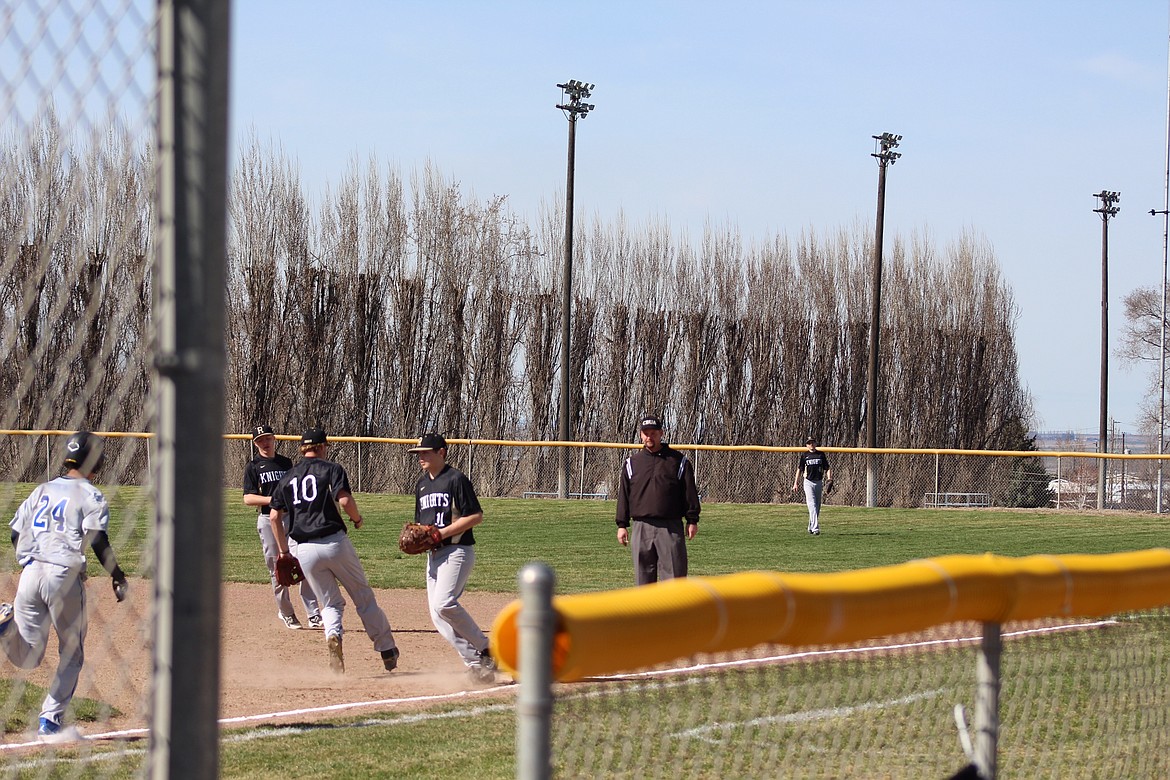 Courtesy photo - Knights pitcher Kaden Jenks and first-baseman J.C. Worsham work to get a Warden runner out during a double-header game last Friday.