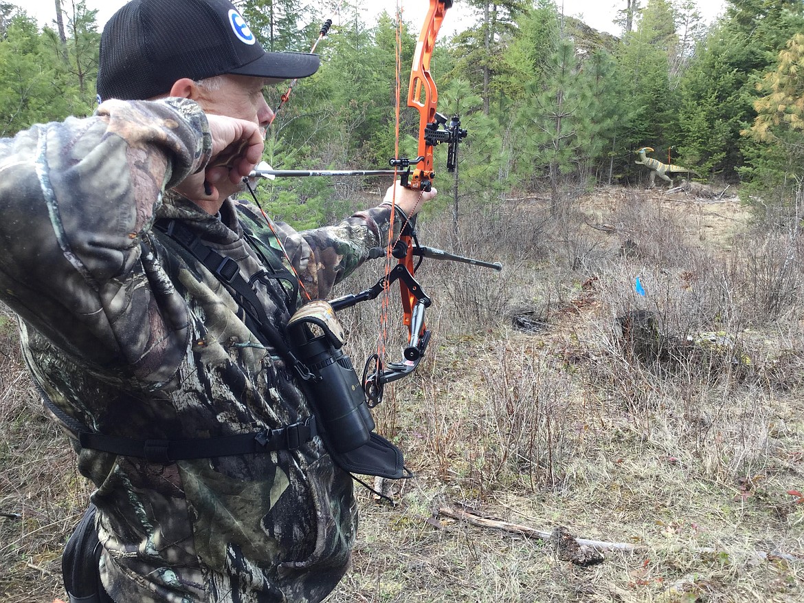 RYAN COLLINGWOOD/Press
John Hamburg shoots at a 3D dinosaur Sunday at the Coeur d&#146;Alene Bowmen&#146;s 3D Snow Shoot near Farragut State Park.