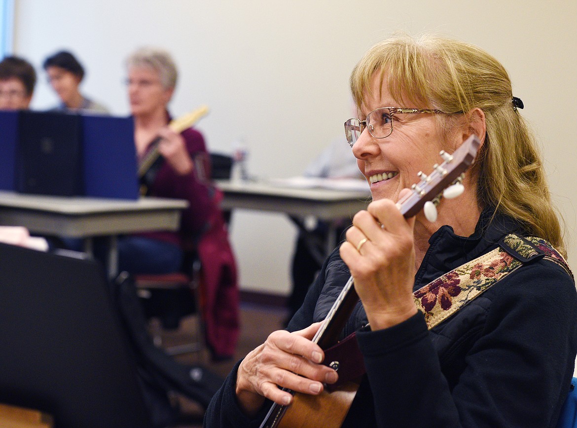 Lorraine Reid finishes a song during a Flathead Valley Community College continuing education intermediate ukelele course on Thursday. (Aaric Bryan/Daily Inter Lake)