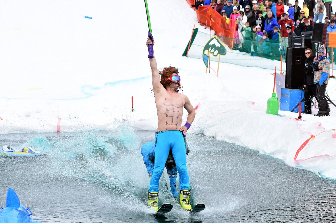 TJ Habel shows off during the annual pond skim competition Saturday at Whitefish Mountain Resort. The annual event marks the end of ski season. (Heidi Desch/Whitefish Pilot)