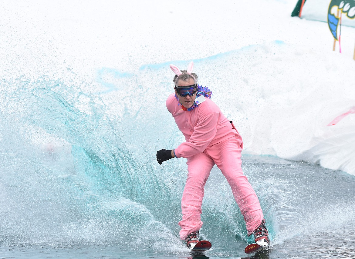 Dana Sanderson as a pink bunny makes his way across the pond during the pond skim competition Saturday at Whitefish Mountain Resort. The annual event marks the end of ski season. (Heidi Desch/Whitefish Pilot)