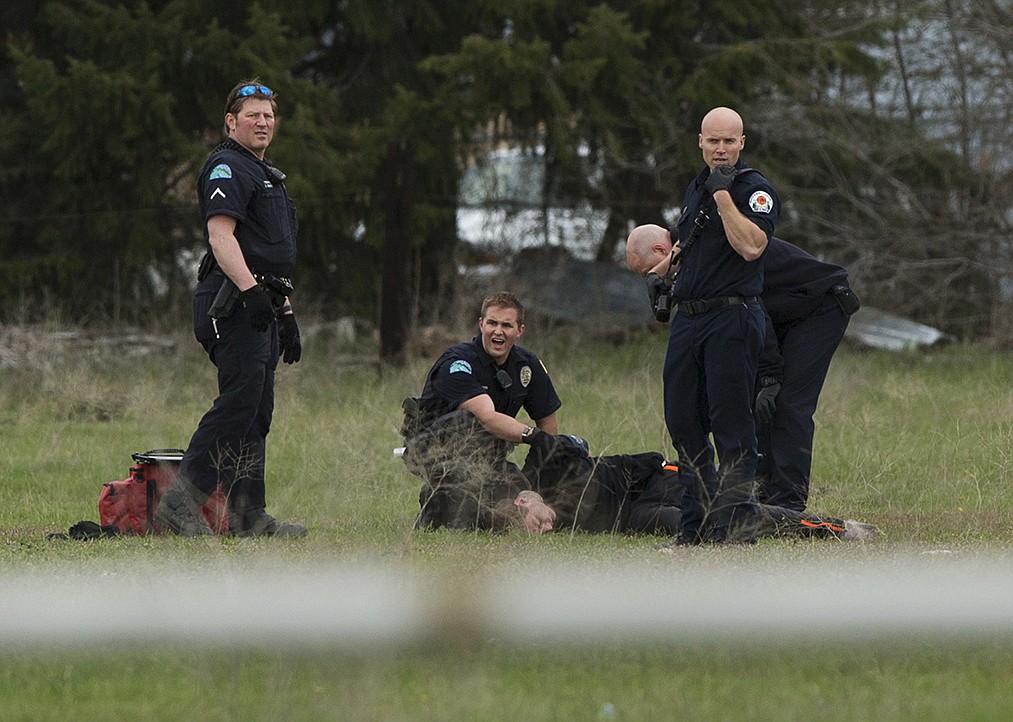 LISA JAMES/PressPost Falls police attend to Brandon Ross after a foot chase that ended with police using a stun gun to subdue Ross. The foot chase lasted about 30 minutes after Ross was found wandering in neighborhoods around 12th Avenue. Ross has multiple warrants, according to police, and was believed to be under the influence.