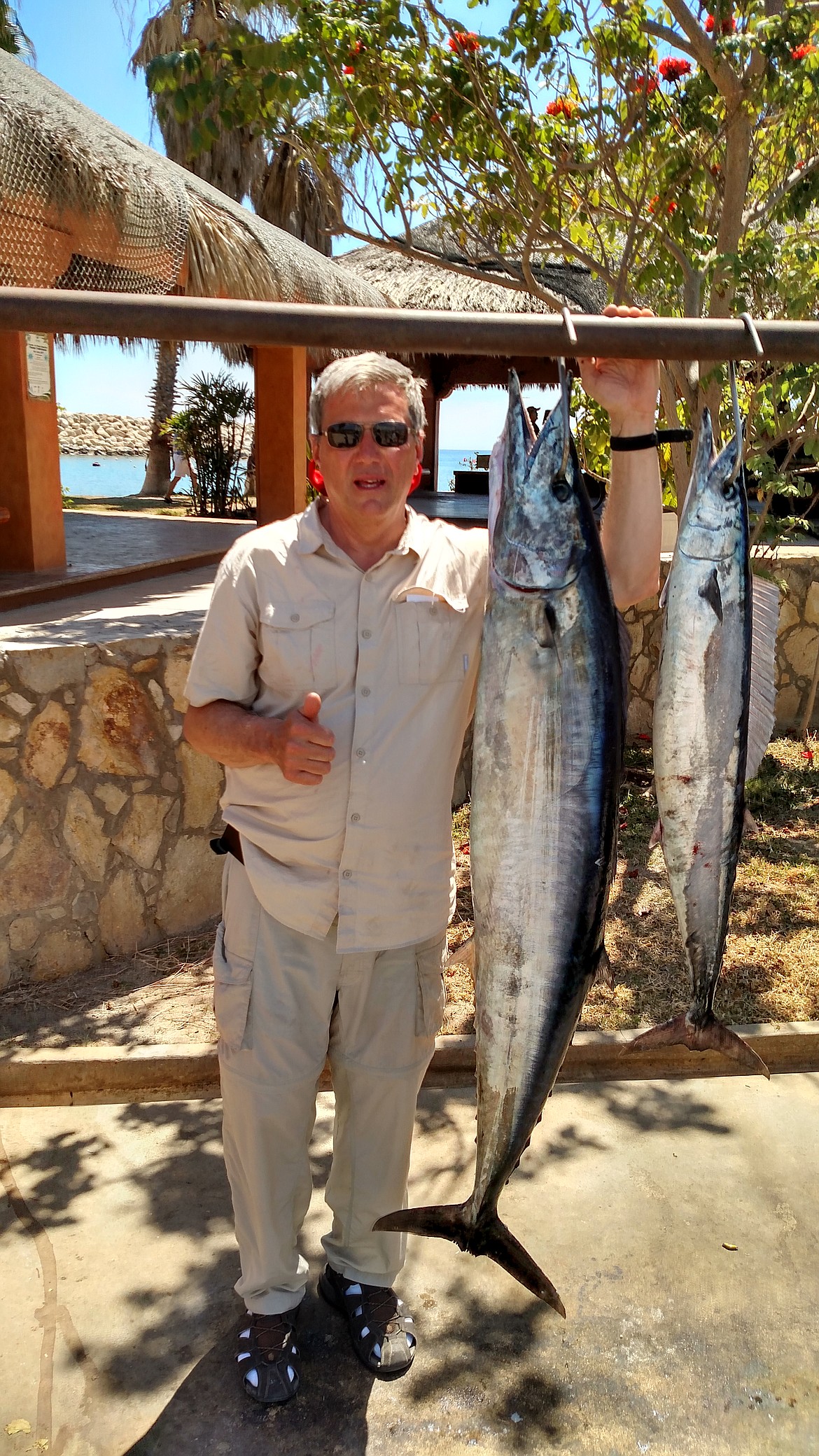 Matt Roetter poses with a pair of wahoo he hooked while vacationing in Mexico. The larger fish weighed 75 pounds.