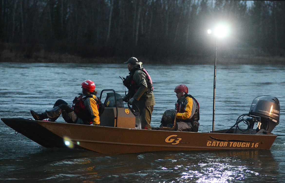 Flathead County Search and Rescue crew members launch a boat at the Old Steel Bridge in Evergreen on Wednesday evening. (Matt Baldwin/Daily Inter Lake)