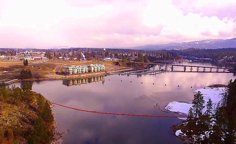 Courtesy photo
The 142-slip marina on the Spokane River in Post Falls, in the center of the photo, has been sold along with 1.8 acres of waterfront property to the right of the condominiums. The new owners, Tom and Hayden Anderl and John Magnuson, plan to have the marina in operation this summer and start work on a 20-unit condominium building with parking and garages later this summer. An access to the waterfront from Spokane Street will also be constructed.