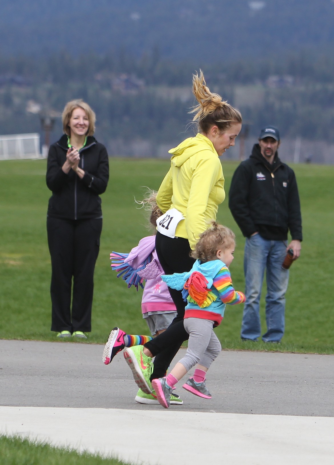 JASON ELLIOTT/Press
Greta Baumgadon crosses the finish line with her daughters during Sunday's Spring Dash race at McEuen Park in Coeur d'Alene. A total of 736 competitors competed in the race, a fundraiser for the United Way of North Idaho.