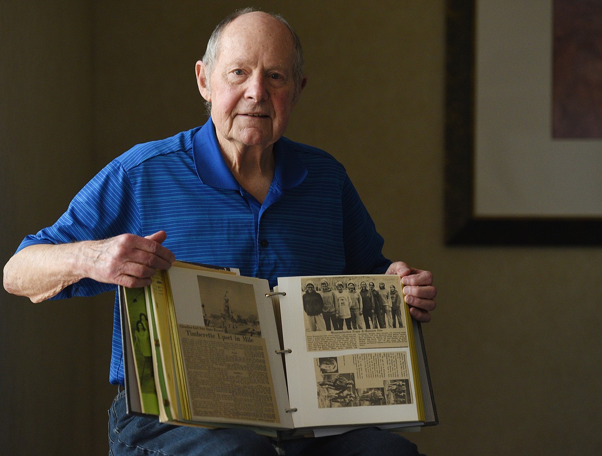 FVCC&#146;S girls track coach Neil Eliason shows off one of his scrap books recounting a successful decade in the sport. (Aaric Bryan/Daily Inter Lake)